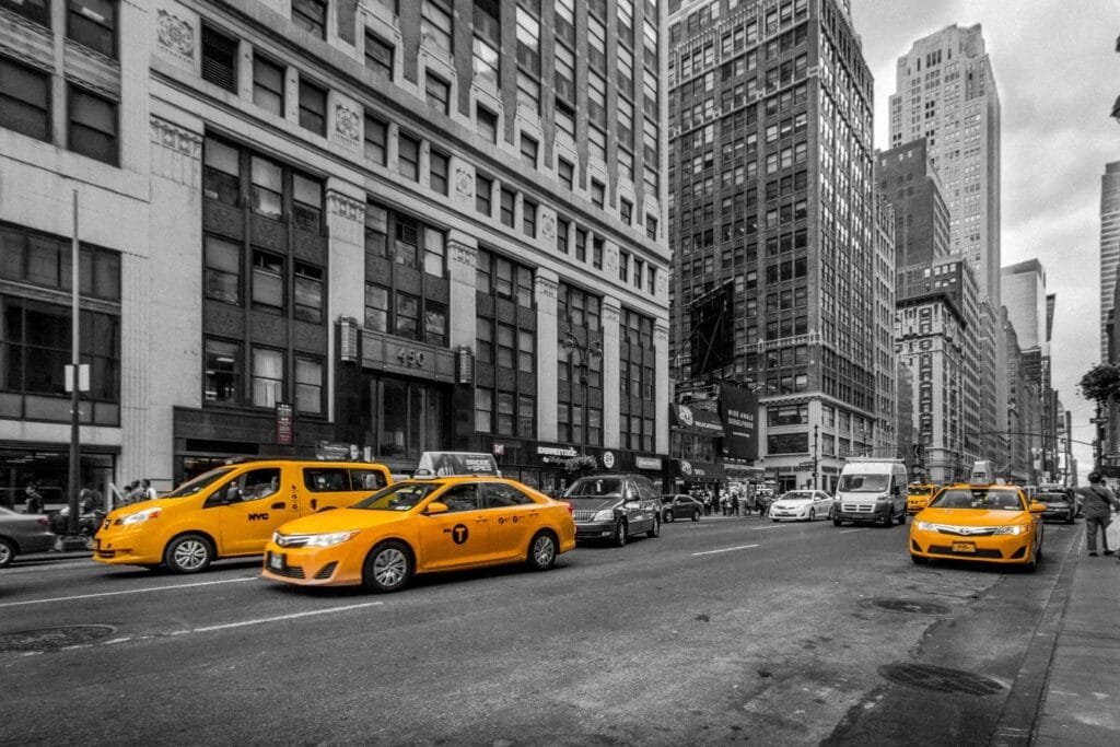 Classic yellow cab in bustling Midtown Manhattan, capturing the energy of New York City